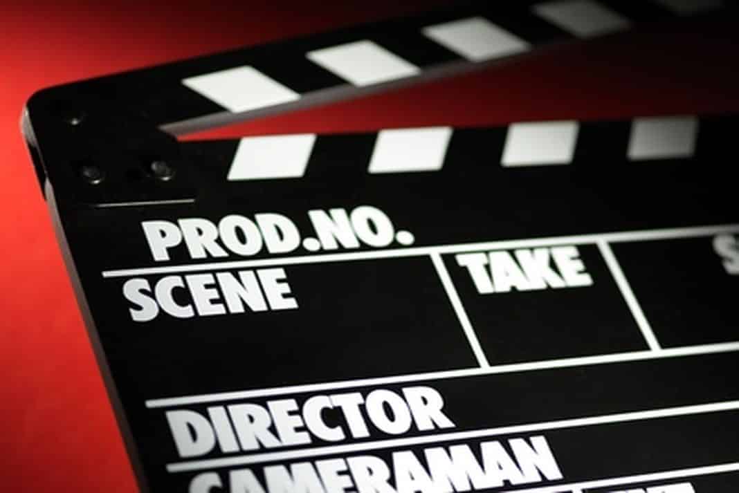 Clapper board on red background